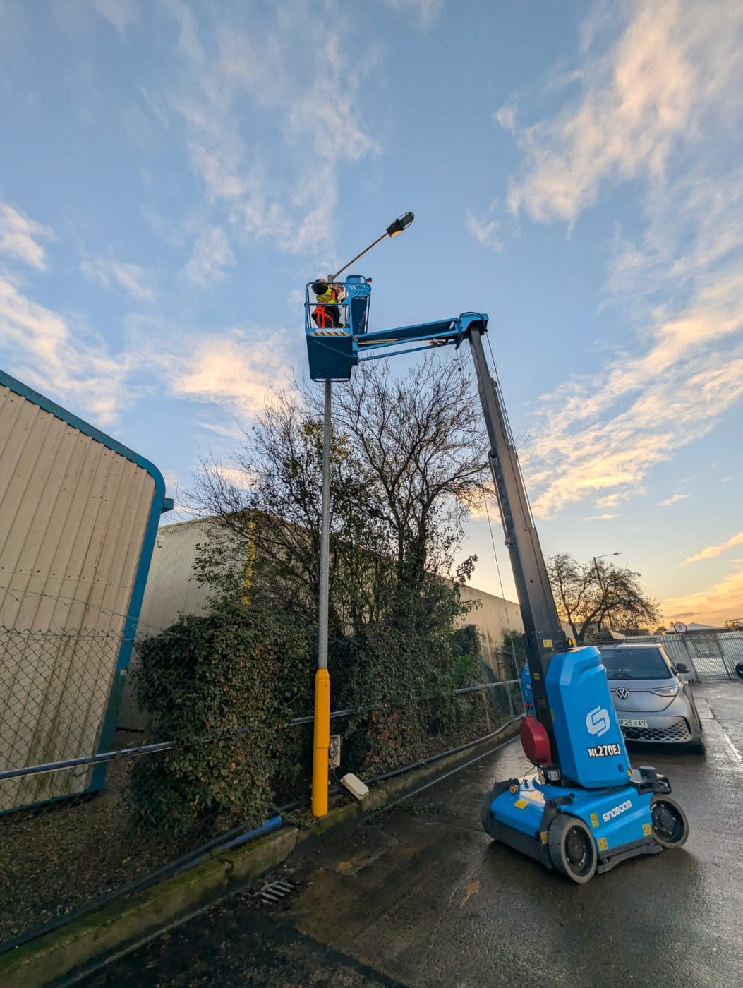 Hawthorne engineer installing a monitored camera from a boom lift